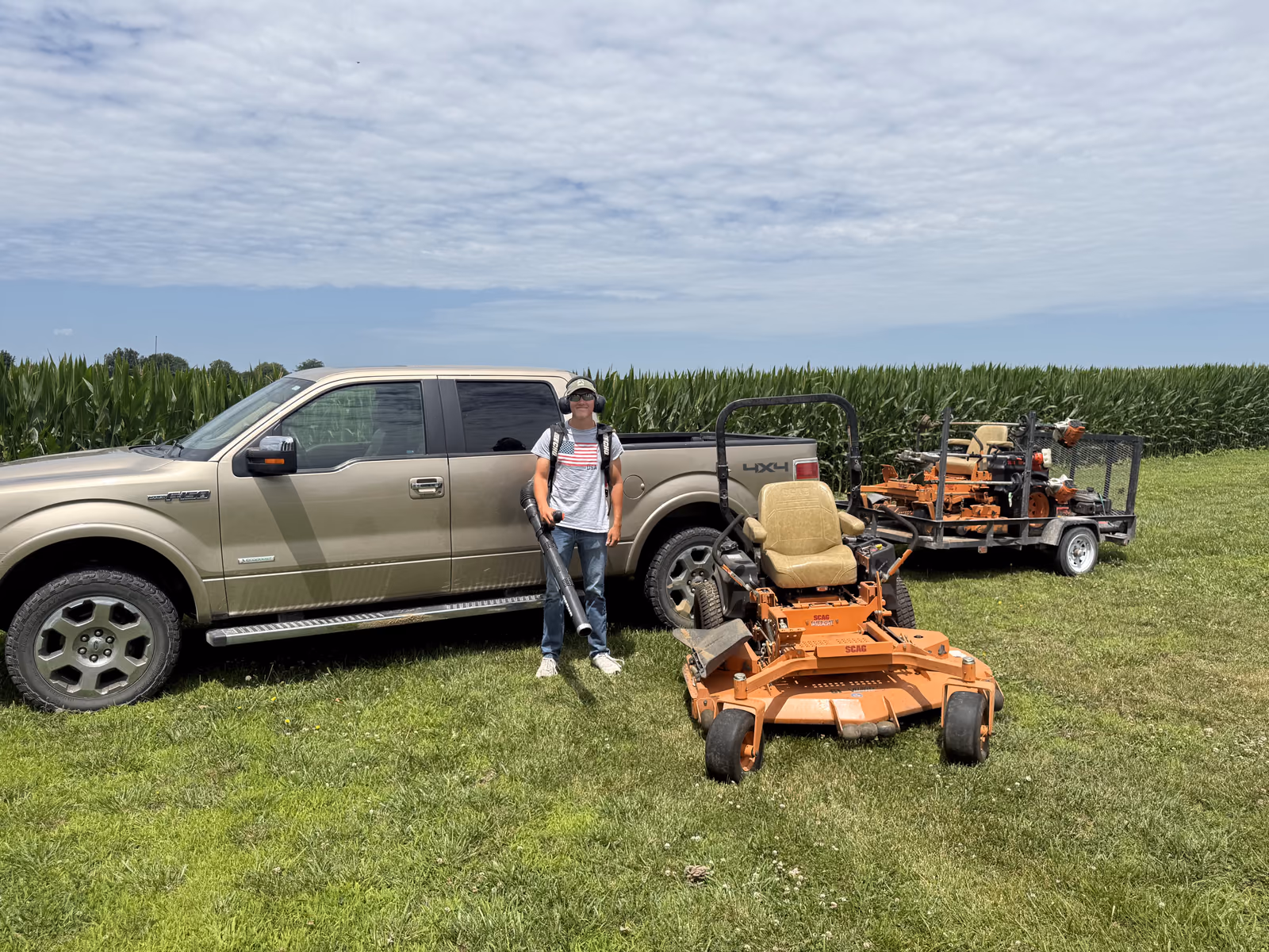 Justin Sipes, owner of Sipes Lawn Care, with his truck and zero-turn mower near Washington, Indiana